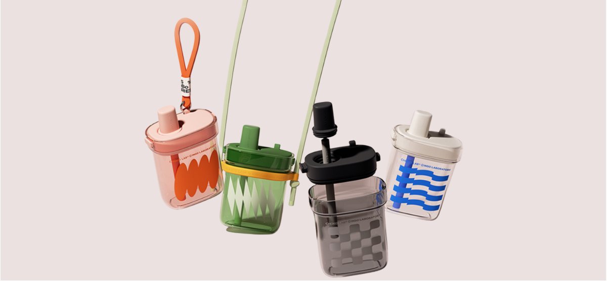 Four Chako Lab Square Cup straw bottles in pink, green, black and white hanging by their straps