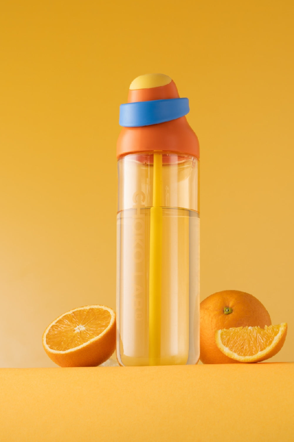 Kada Cup 888ml bottle in Marigold beside fresh oranges