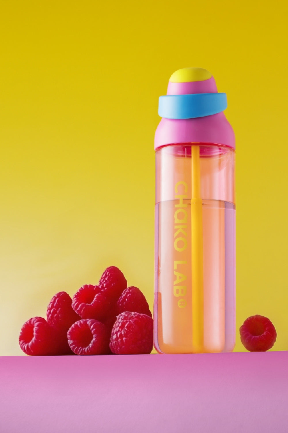 Kada Cup 888ml bottle in Rosewater beside raspberries